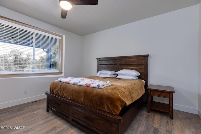 bedroom with wood finished floors, baseboards, and ceiling fan