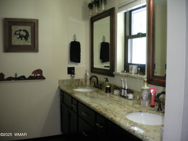full bath featuring a sink and double vanity
