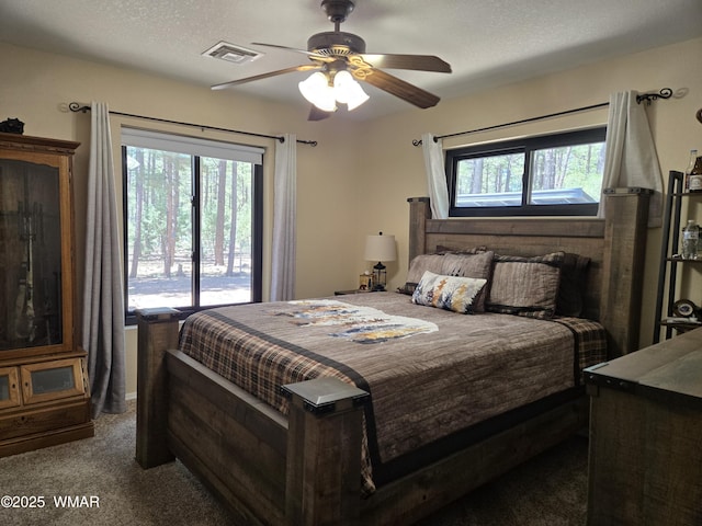 bedroom featuring multiple windows, carpet, ceiling fan, and visible vents