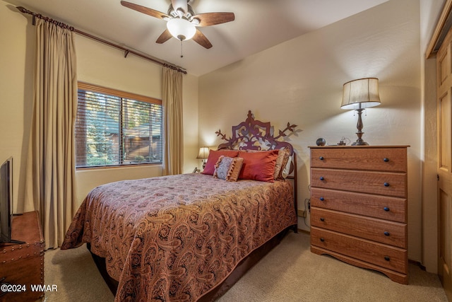 bedroom featuring ceiling fan and light colored carpet