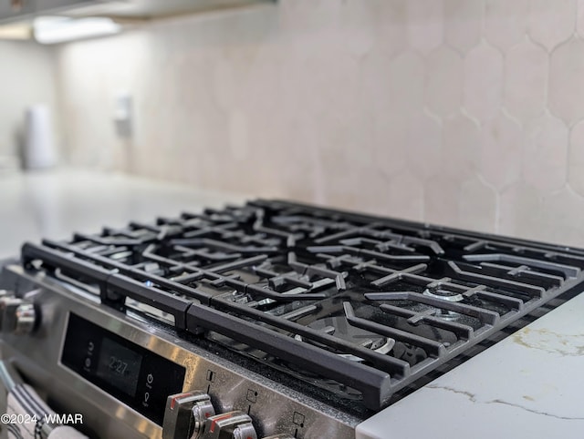 details with stone countertops and stainless steel gas range oven