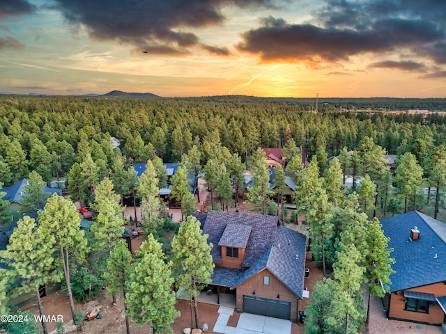 birds eye view of property featuring a view of trees