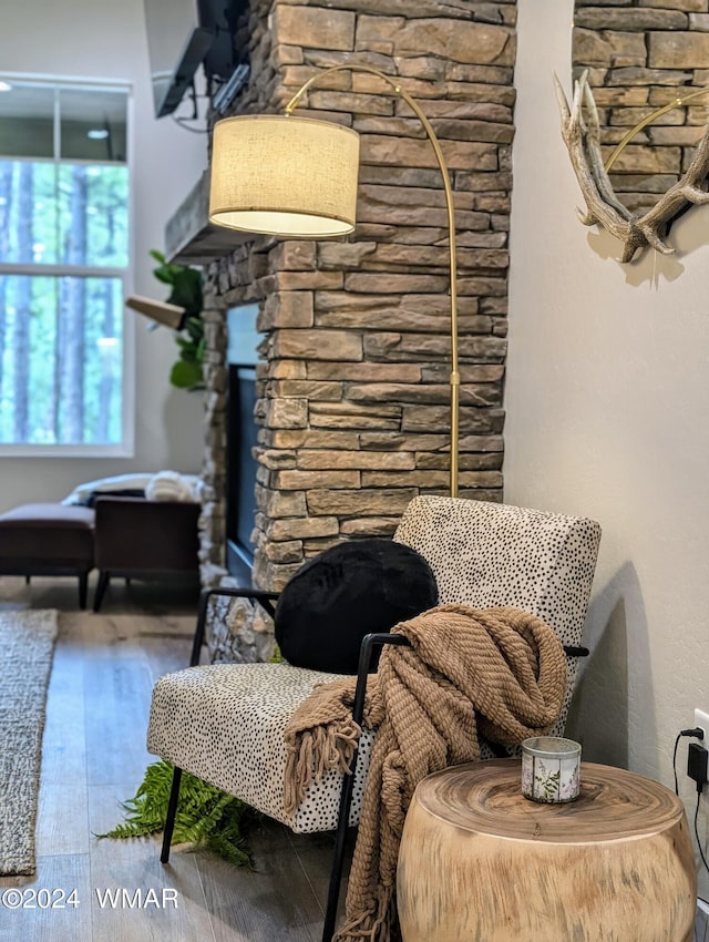 living area with a fireplace and wood finished floors