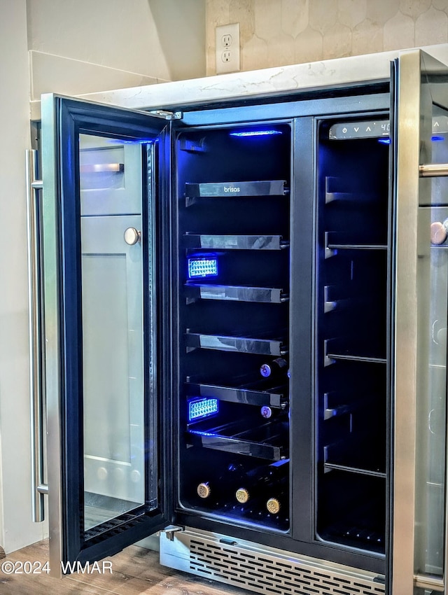 bar featuring wine cooler and wood finished floors