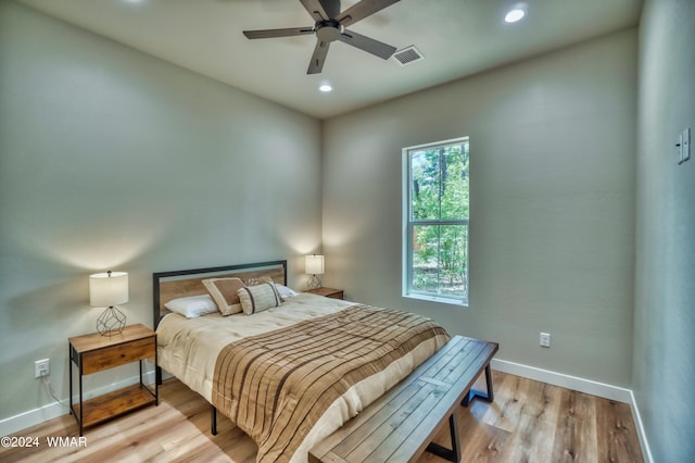 bedroom with recessed lighting, visible vents, light wood-style flooring, and baseboards