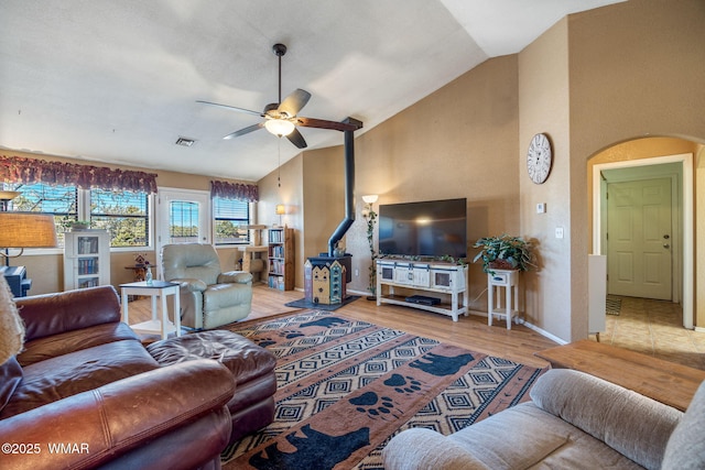 living room featuring ceiling fan, high vaulted ceiling, wood finished floors, and baseboards