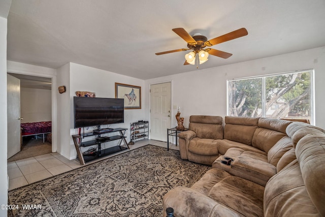 living room with a ceiling fan and light tile patterned flooring