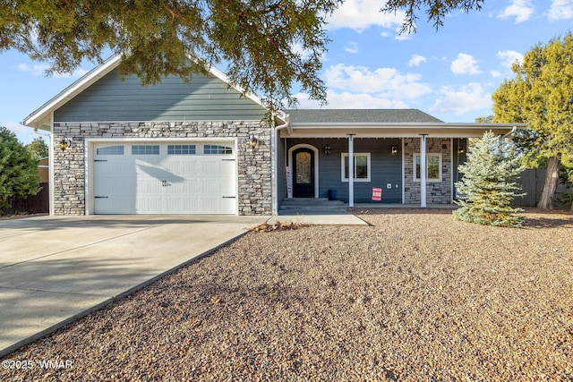 ranch-style home featuring driveway, stone siding, and an attached garage