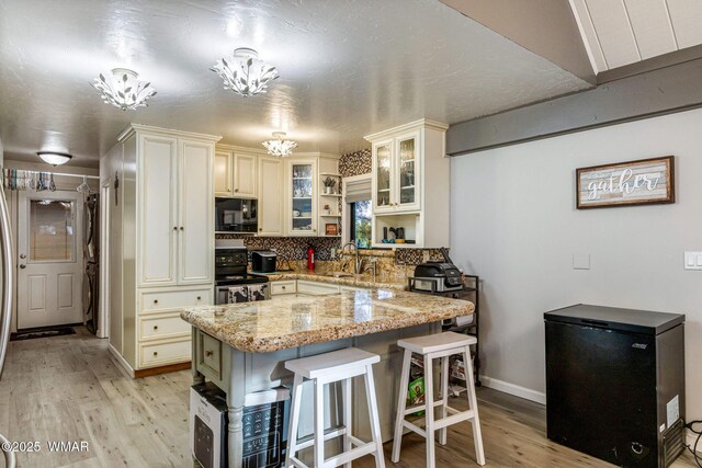 2331 W Rogers Loop, Show Low, AZ 85901 - kitchen featuring black microwave, refrigerator, range with electric cooktop, light wood-style flooring, and light stone countertops