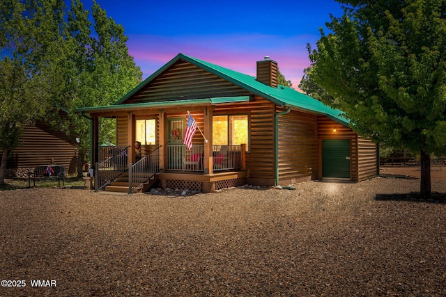 2649 Palomino Trl, Overgaard, AZ 85933 - chalet / cabin with covered porch, a chimney, metal roof, and faux log siding