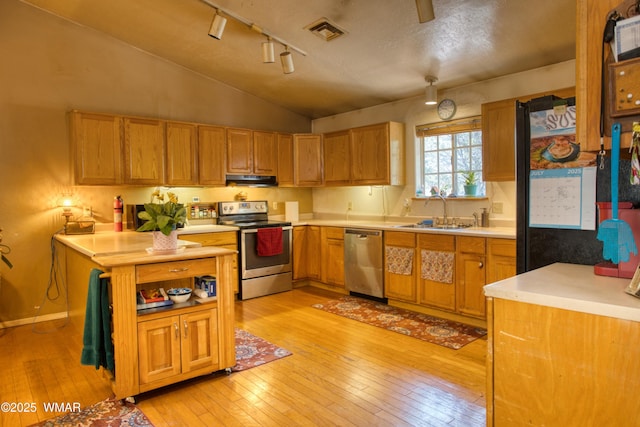 6690 Circle C Ln, Show Low, AZ 85901 - kitchen with stainless steel appliances, light wood-type flooring, lofted ceiling, light countertops, and under cabinet range hood