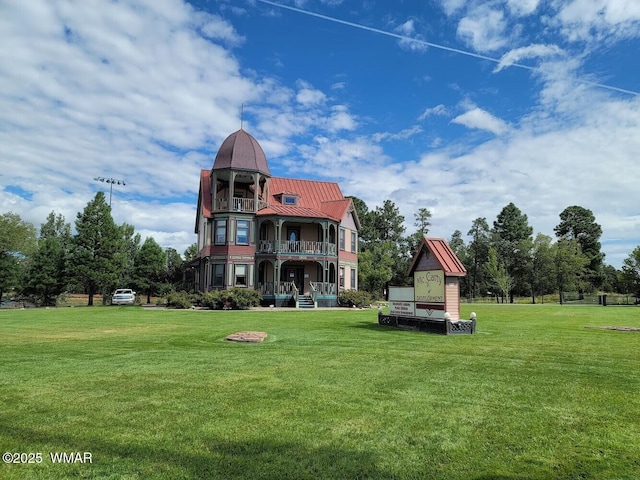 6690 Circle C Ln, Show Low, AZ 85901 - back of property featuring a balcony, a lawn, and a metal roof