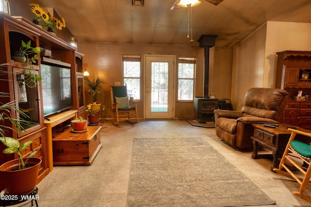 6690 Circle C Ln, Show Low, AZ 85901 - living room featuring a wood stove, ceiling fan, and carpet