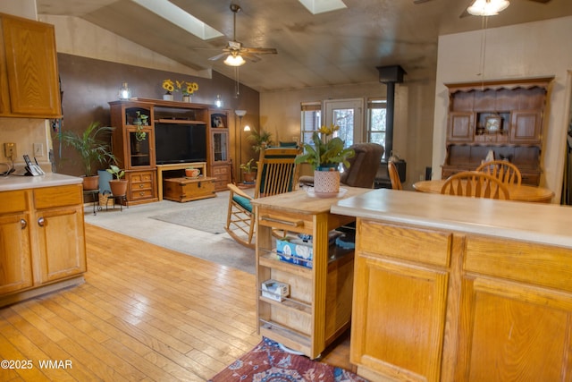 6690 Circle C Ln, Show Low, AZ 85901 - kitchen with a ceiling fan, a skylight, a wood stove, open floor plan, and lofted ceiling
