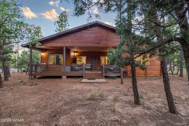 rear view of property with covered porch