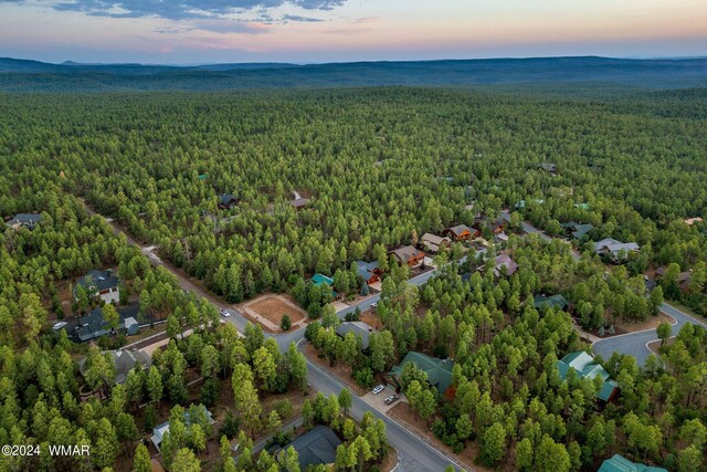 birds eye view of property featuring a view of trees