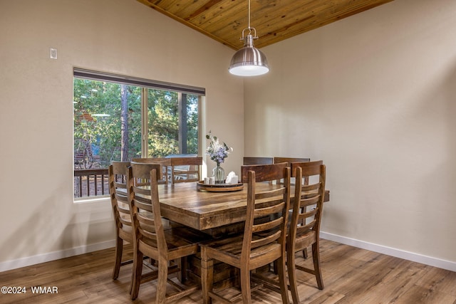 dining area featuring wood ceiling, vaulted ceiling, baseboards, and wood finished floors