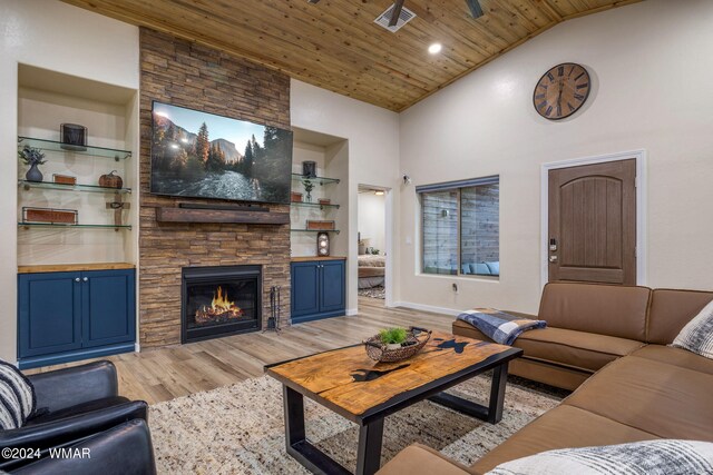 living room featuring high vaulted ceiling, visible vents, wood ceiling, built in features, and light wood finished floors