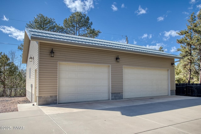 detached garage featuring fence