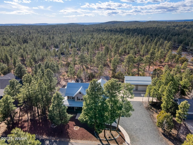 birds eye view of property featuring a view of trees