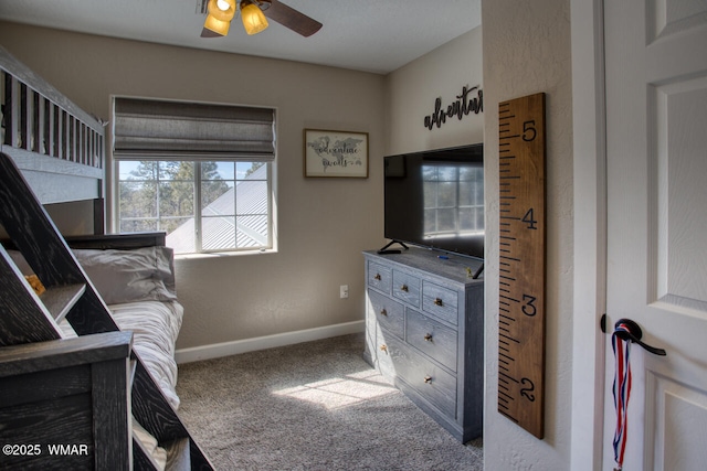 carpeted bedroom with baseboards and ceiling fan