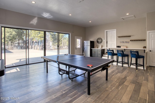 game room with recessed lighting and wood finished floors