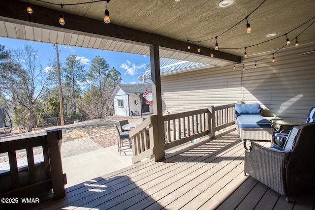 deck featuring an outbuilding and fence