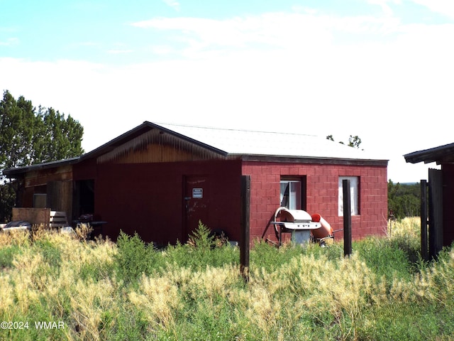 view of home's exterior with concrete block siding