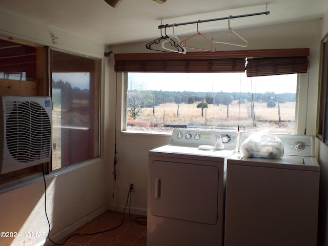 laundry room featuring laundry area, baseboards, a rural view, washer and dryer, and ac unit