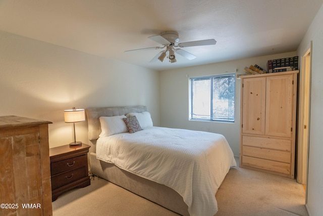 bedroom featuring light carpet and a ceiling fan