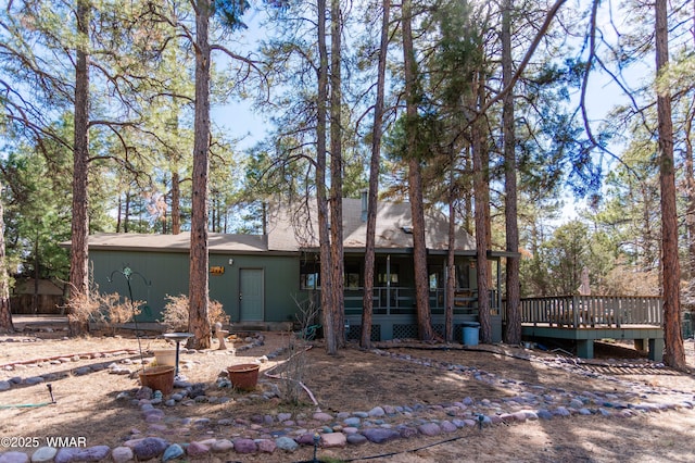 rear view of house with a wooden deck