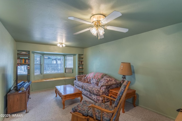 carpeted living room featuring cooling unit, baseboards, and a ceiling fan