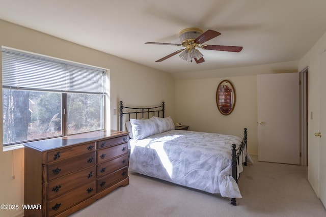 bedroom with ceiling fan and light colored carpet