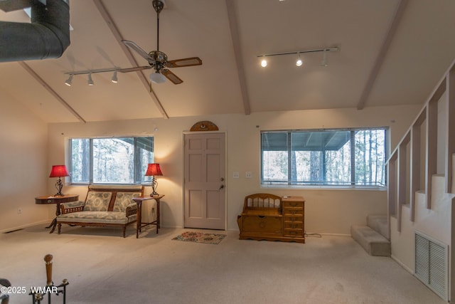 carpeted entryway featuring visible vents, ceiling fan, stairway, vaulted ceiling with beams, and rail lighting