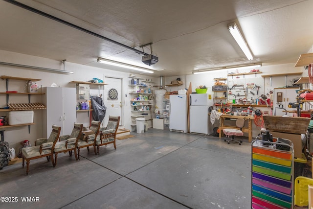 garage with a garage door opener, freestanding refrigerator, and a workshop area