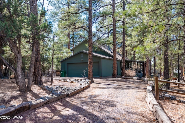 view of front of property featuring gravel driveway and an attached garage