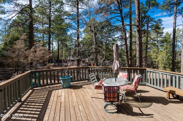 wooden terrace with outdoor dining space