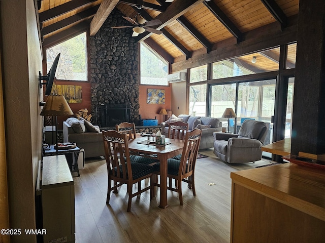 4989 Drifting Snow Loop Unit 4, Pinetop, AZ 85935 - dining room with wood ceiling, a ceiling fan, a fireplace, a wall mounted air conditioner, and beamed ceiling