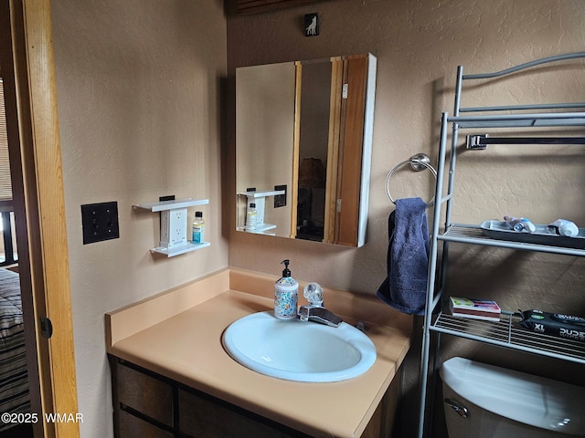 4989 Drifting Snow Loop Unit 4, Pinetop, AZ 85935 - half bathroom with vanity, a textured wall, and toilet