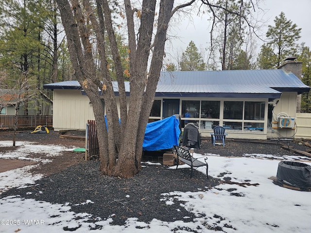 4989 Drifting Snow Loop Unit 4, Pinetop, AZ 85935 - snow covered house featuring a sunroom, fence, and a chimney