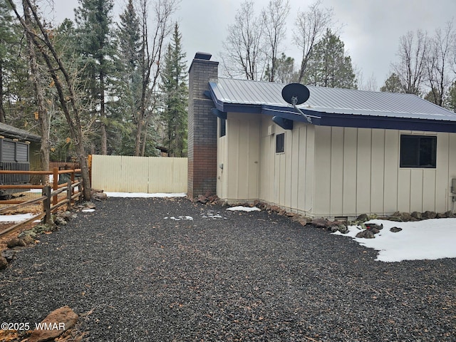 4989 Drifting Snow Loop Unit 4, Pinetop, AZ 85935 - view of property exterior with fence, a chimney, and metal roof