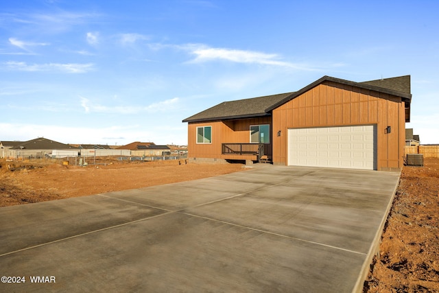 view of front facade with an attached garage, a shingled roof, fence, driveway, and crawl space