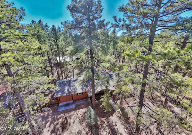 birds eye view of property featuring a view of trees