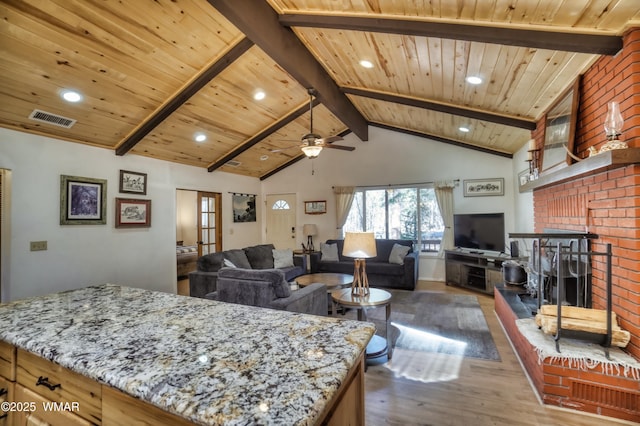 interior space featuring light stone counters, wooden ceiling, visible vents, open floor plan, and beamed ceiling