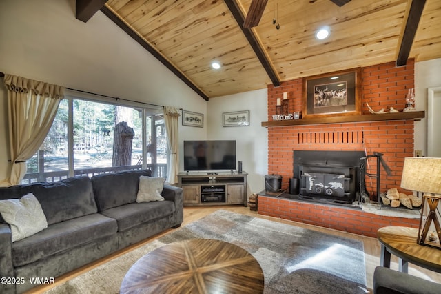 living area with wood ceiling, beam ceiling, a fireplace, and wood finished floors