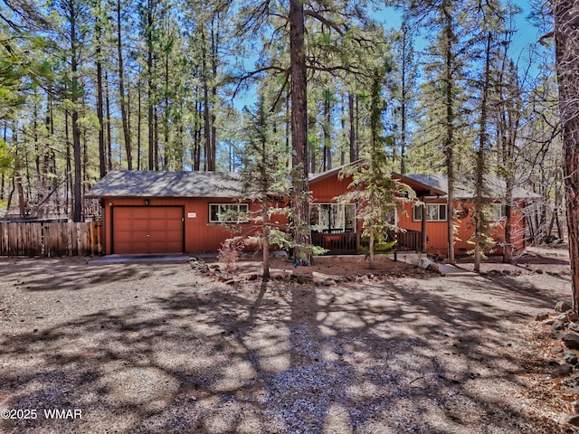 chalet / cabin with driveway and an attached garage