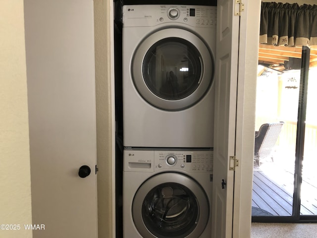 laundry area with laundry area and stacked washer and clothes dryer