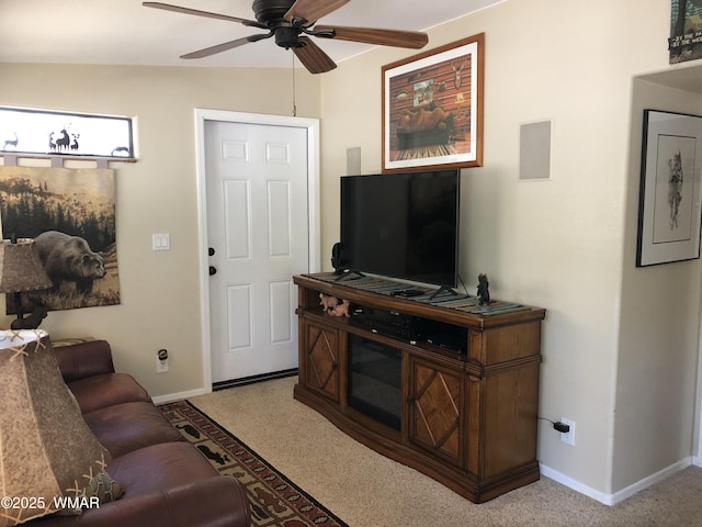living room with ceiling fan, carpet, and baseboards