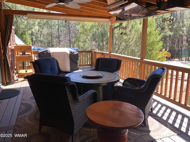 wooden deck featuring a ceiling fan and area for grilling