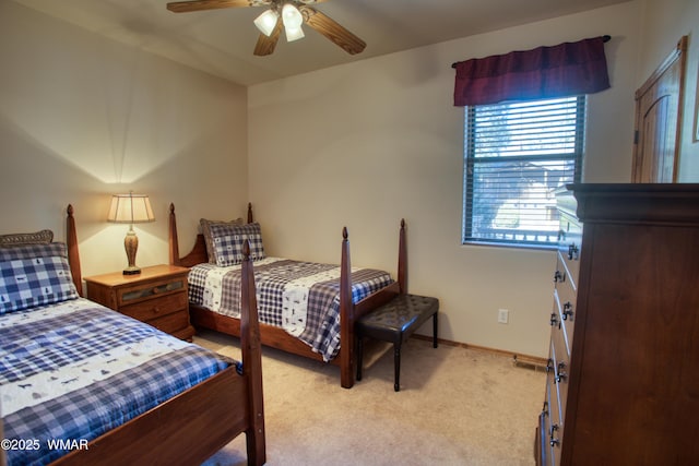 bedroom with light carpet, ceiling fan, and baseboards